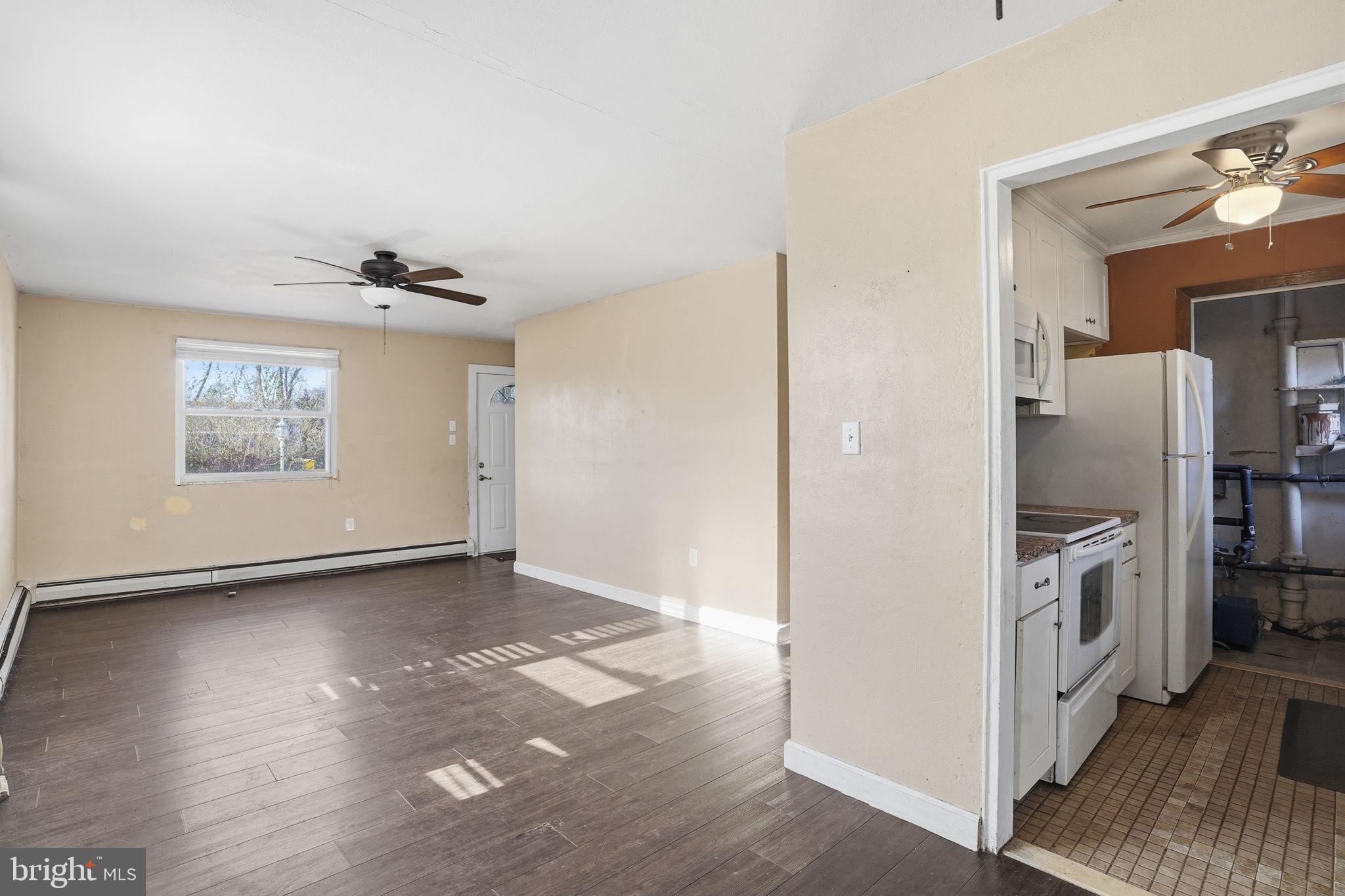 610 Wardour Road Glen Burnie, MD 21061 - Photo 7 of 19 a view of a kitchen with refrigerator and wooden floor
