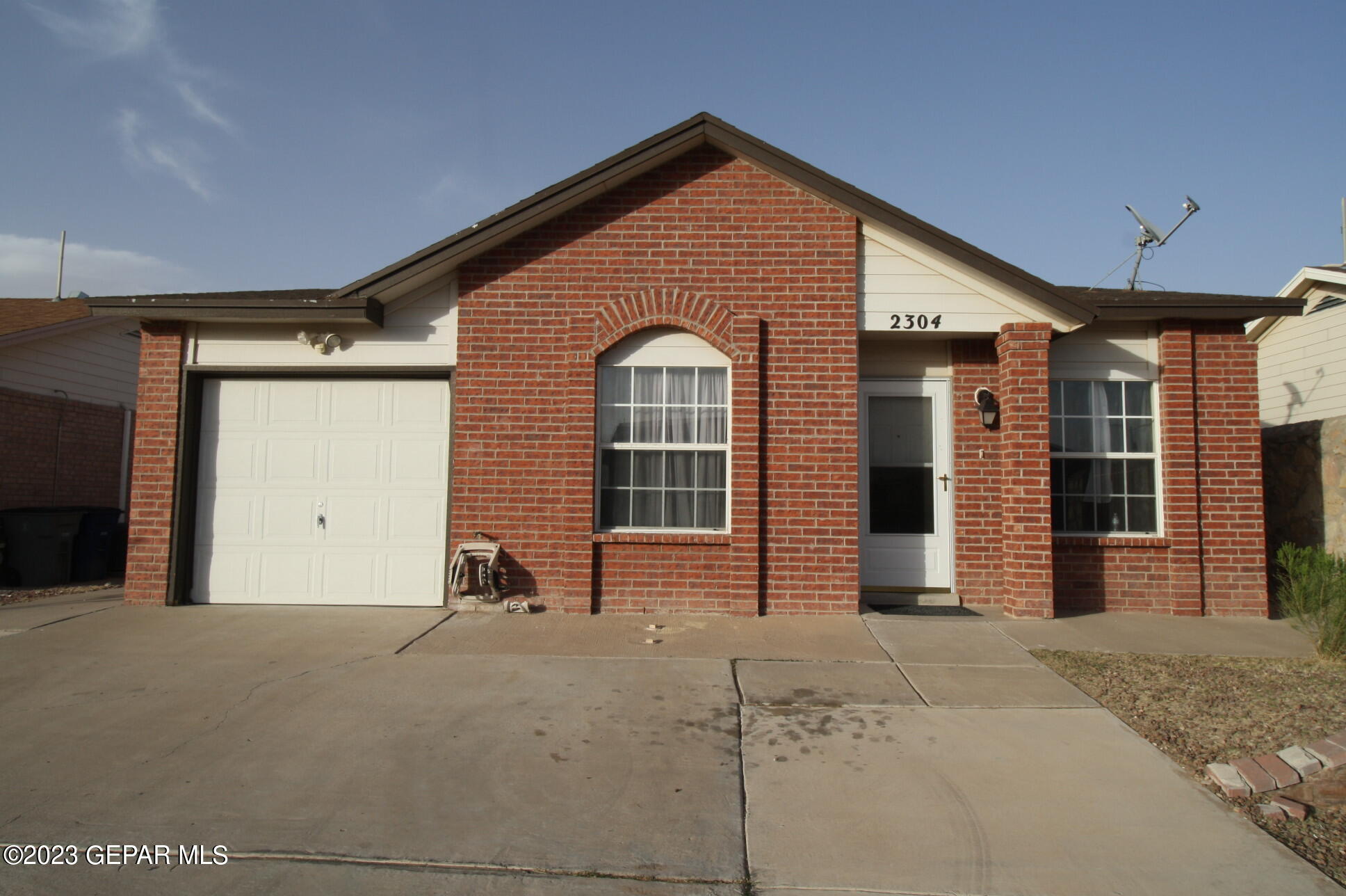 2304 Tierra Serena Road El Paso, TX 79938 - Photo 1 of 1 a front view of a house with a garden