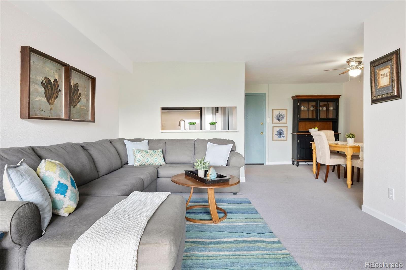 2 Adams Street, Unit 806 Denver, CO 80206 - Photo 11 of 34 a living room with furniture and wooden floor