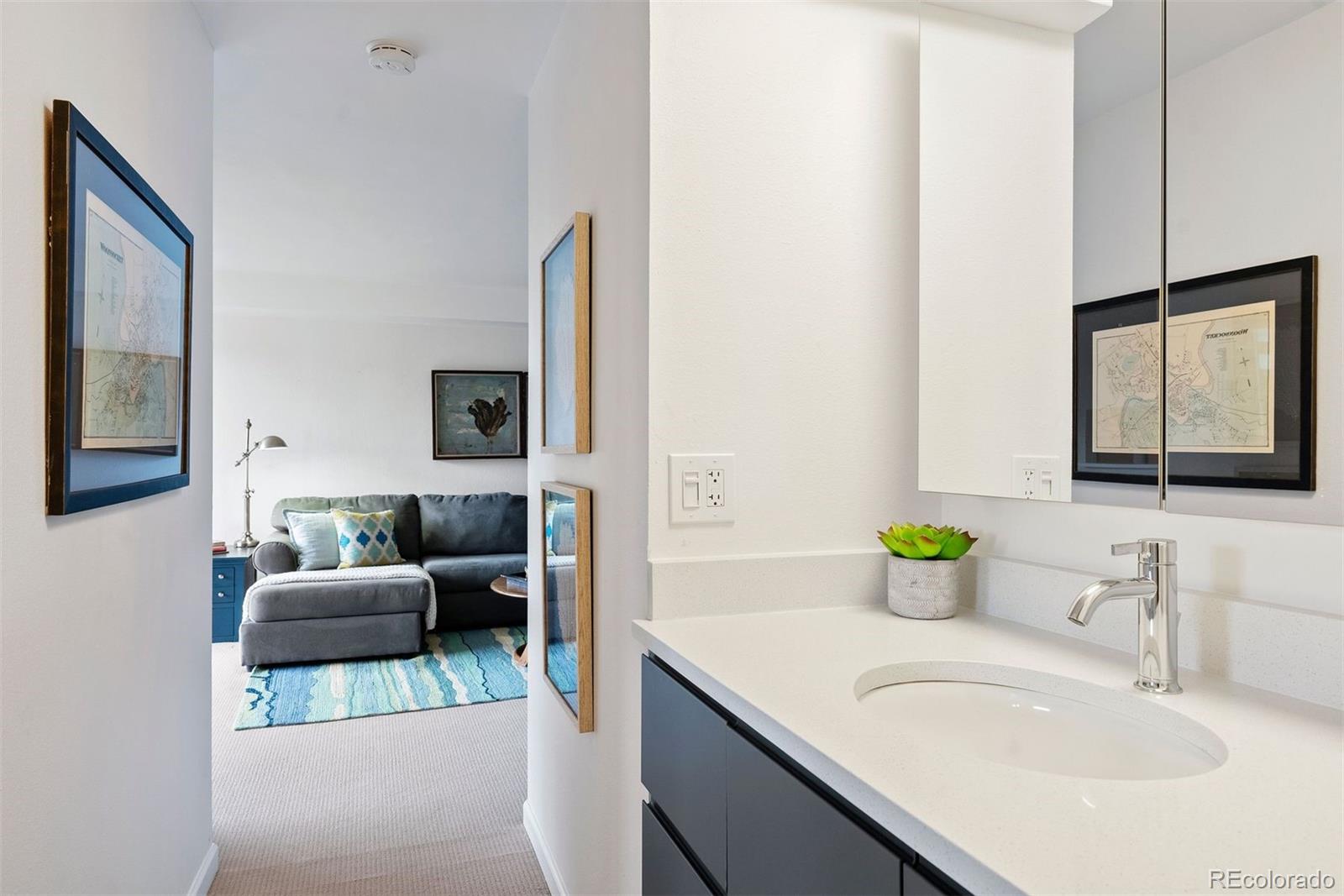 2 Adams Street, Unit 806 Denver, CO 80206 - Photo 12 of 34 a en suite bathroom with a granite countertop sink and a mirror