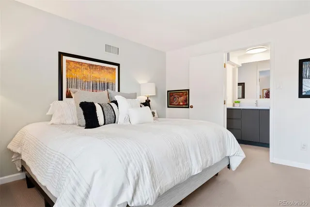 a kitchen with a refrigerator sink and cabinets