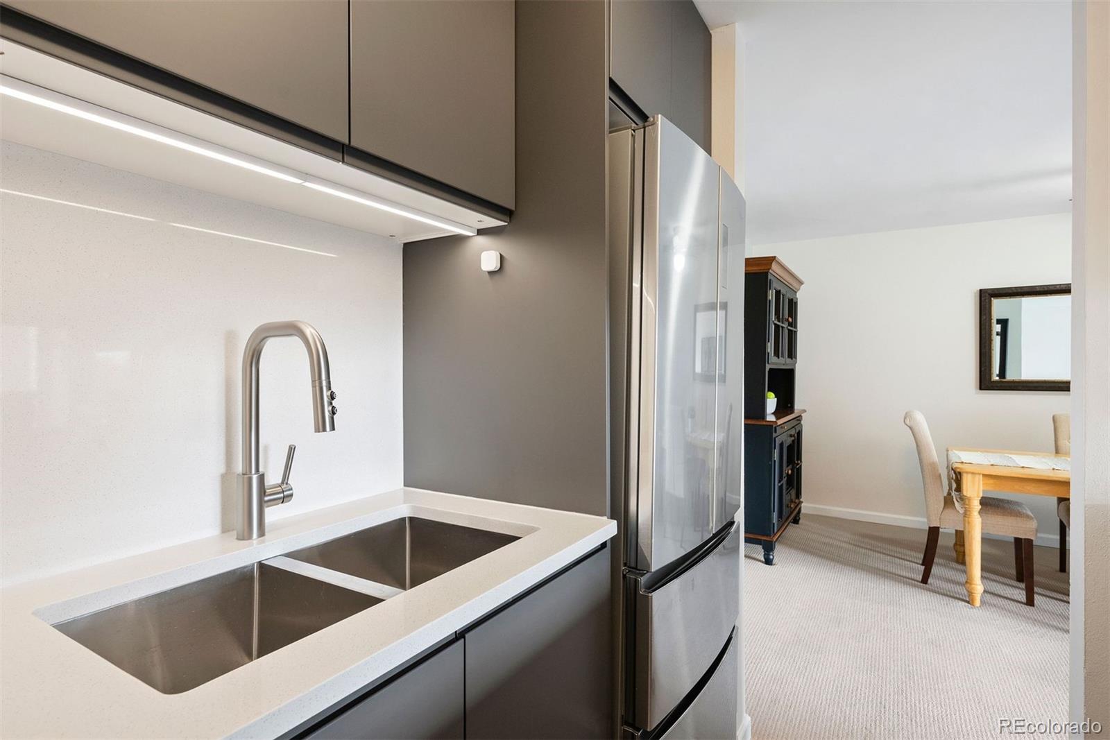 2 Adams Street, Unit 806 Denver, CO 80206 - Photo 17 of 34 a kitchen with a refrigerator sink and cabinets