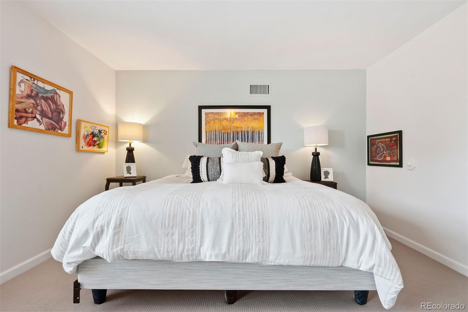 2 Adams Street, Unit 806 Denver, CO 80206 - Photo 23 of 34 a bedroom with a bed and window