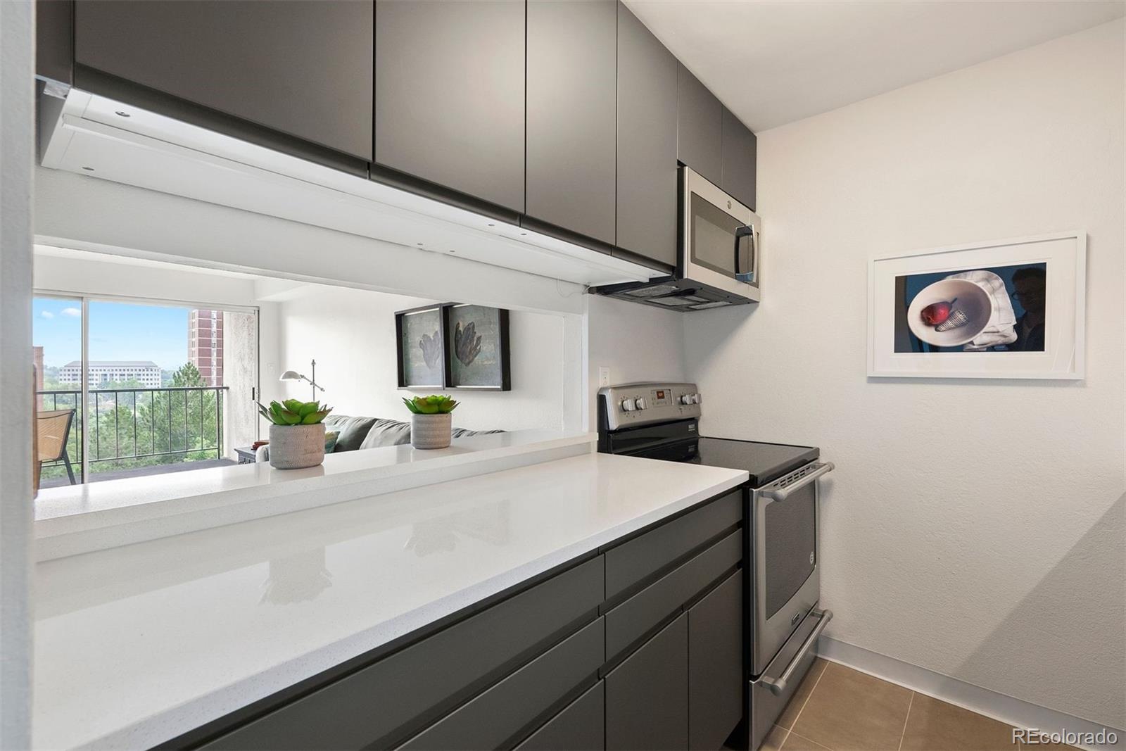 2 Adams Street, Unit 806 Denver, CO 80206 - Photo 7 of 34 a kitchen with a sink and a stove top oven