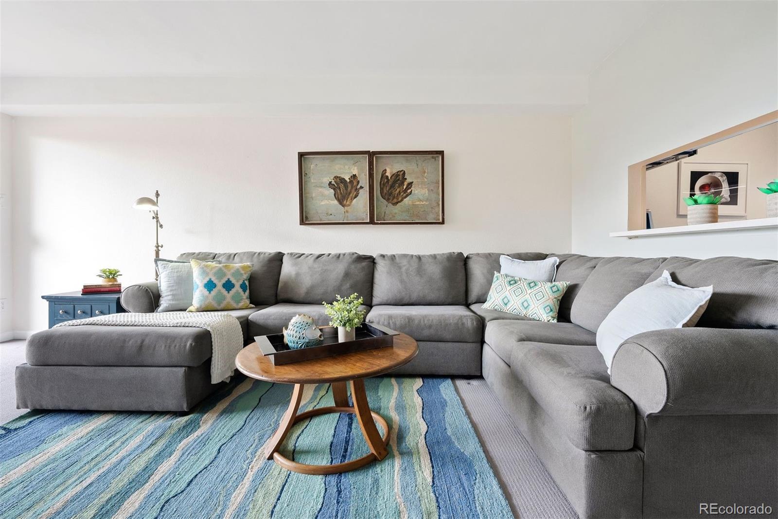 2 Adams Street, Unit 806 Denver, CO 80206 - Photo 10 of 34 a living room with furniture and a wooden floor