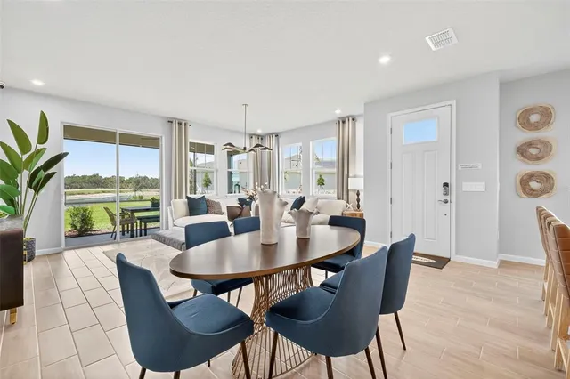 a dining room with furniture and wooden floor