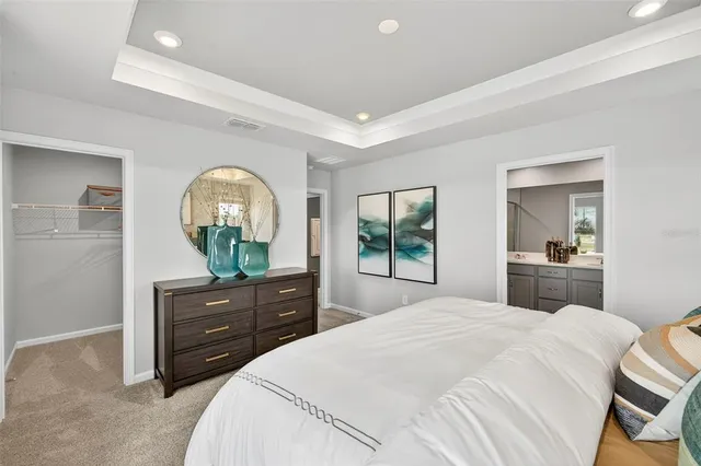 a bedroom with a bed and a mirror on dresser