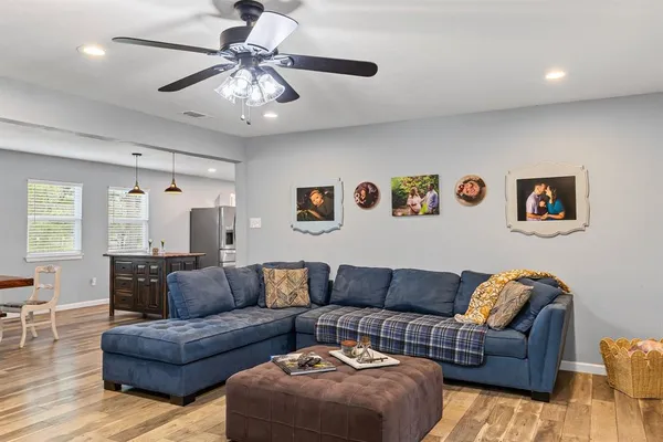 a living room with furniture and a chandelier