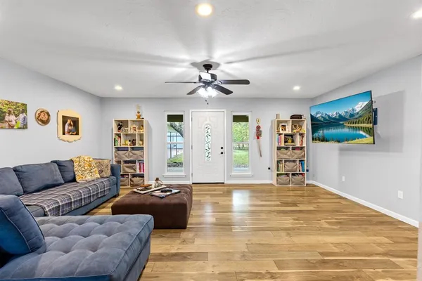 a living room with furniture and wooden floor