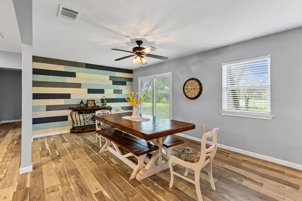 a view of a dining room with furniture window and wooden floor