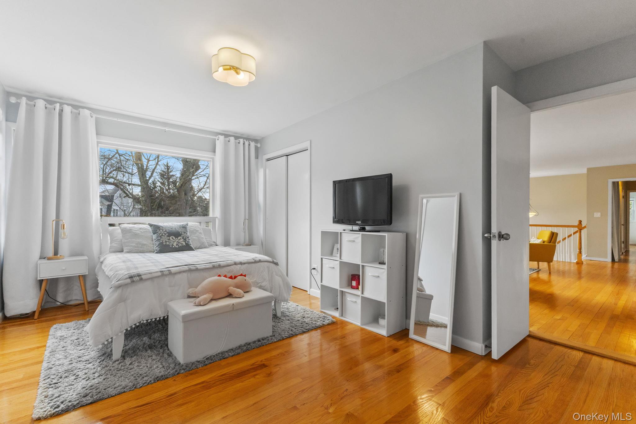 15 Meadow Place Rye, NY 10580 - Photo 16 of 39 One of the main floor bedrooms off the family room, which has an ensuite bath and built-in storage/vanity area. Large window looks out onto the front yard. Doorway at the right leads back into the living room.