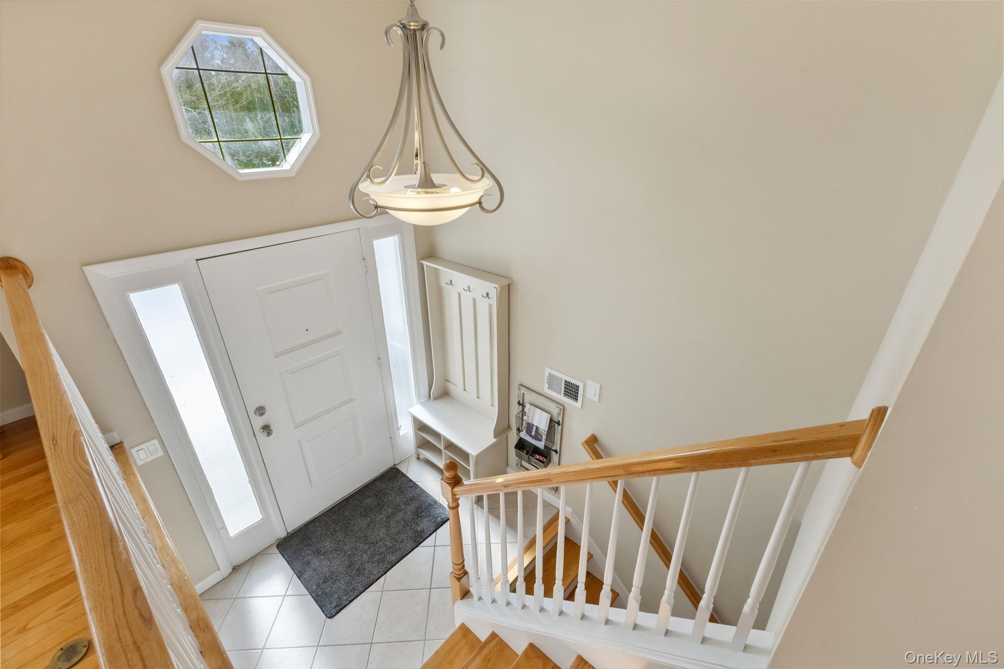 15 Meadow Place Rye, NY 10580 - Photo 2 of 39 Bright entrance foyer with neutral-colored walls, octagon window and chandelier.