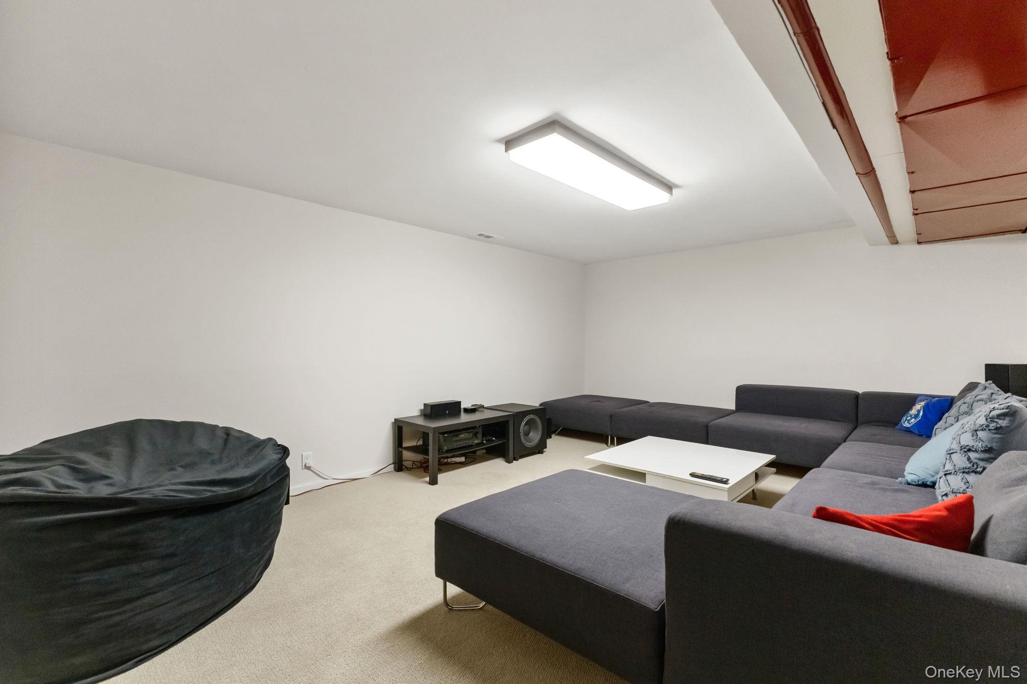 15 Meadow Place Rye, NY 10580 - Photo 27 of 39 Another lower-level room is being used as a home theater. Plenty of room for watching all your favorite movies! Carpeting and double closet.