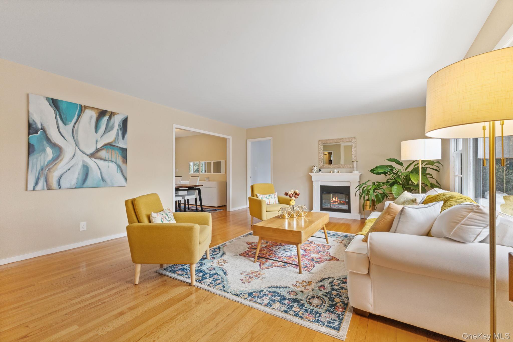 15 Meadow Place Rye, NY 10580 - Photo 3 of 39 Well-appointed living room with tons of natural light, gleaming hardwood floors and neutral walls. Two doorways in the background lead to a formal dining room and one of the 4 bedrooms on main level.