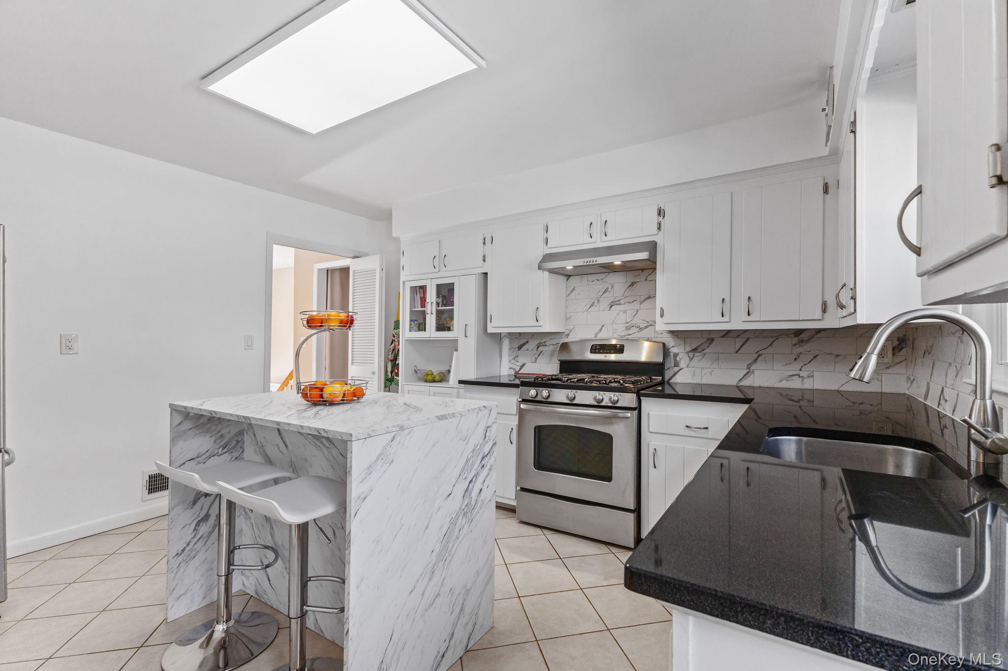 15 Meadow Place Rye, NY 10580 - Photo 9 of 39 Another view of kitchen shows doorway that leads to the front entrance staircase.
