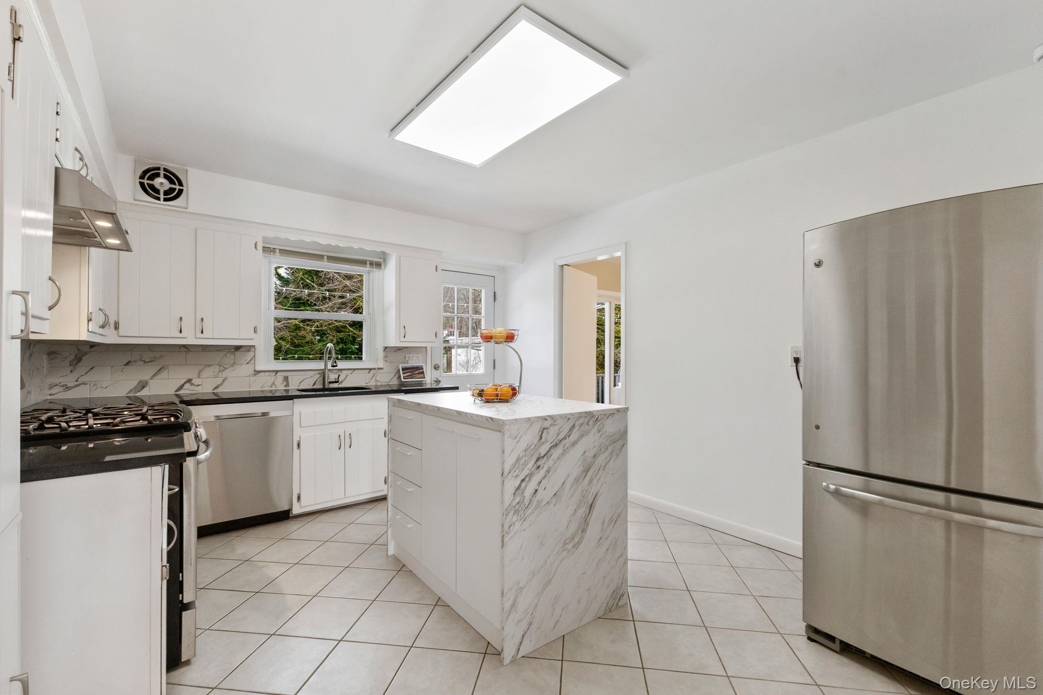 15 Meadow Place Rye, NY 10580 - Photo 10 of 39 Kitchen window looks out onto the private backyard. Door to back deck is to the right of the window. Doorway at far-right leads to a formal dining room.