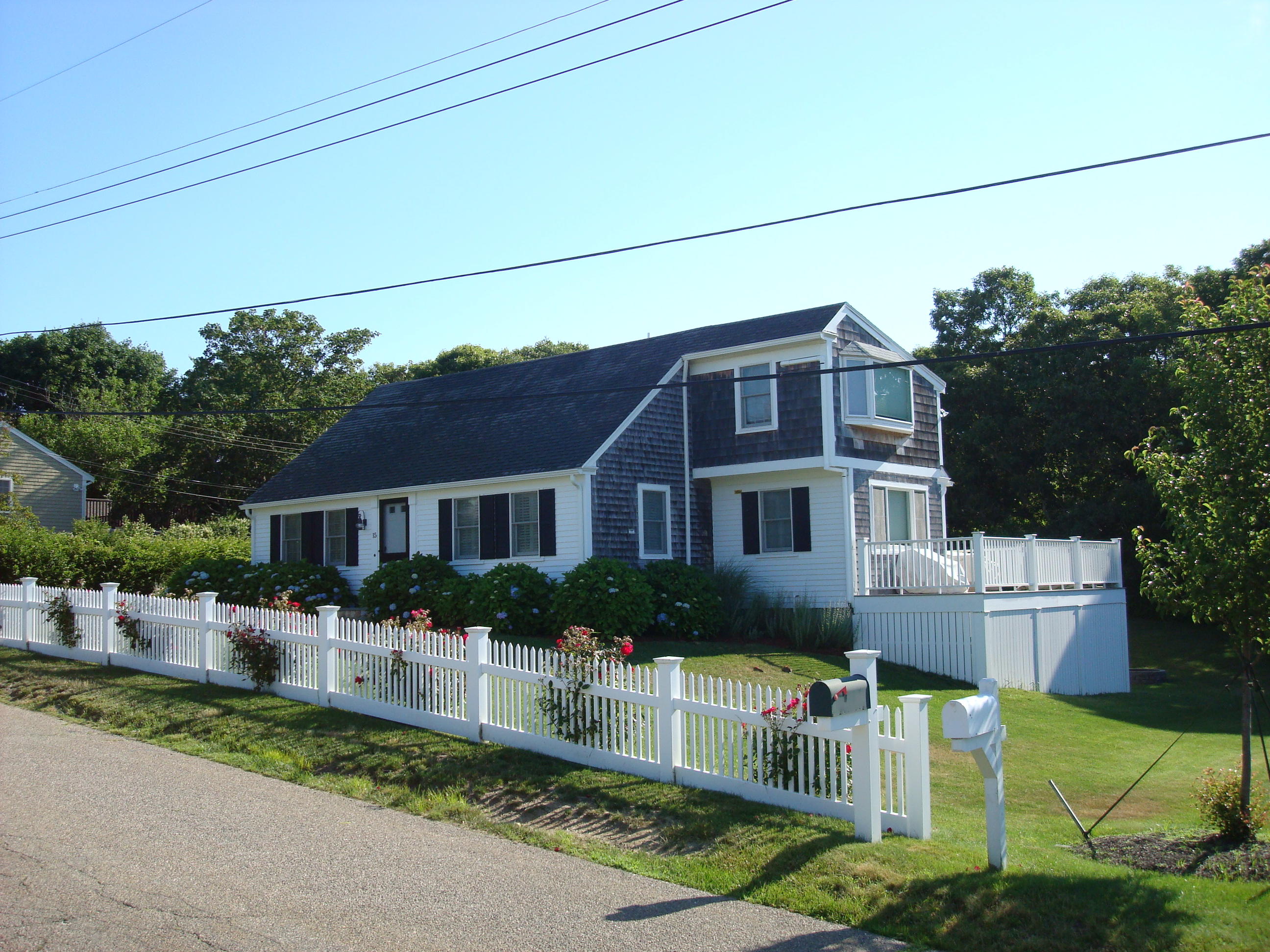 15 Colonial Way Harwich Port, MA 02646 - Photo 2 of 28 a front view of a house with a yard