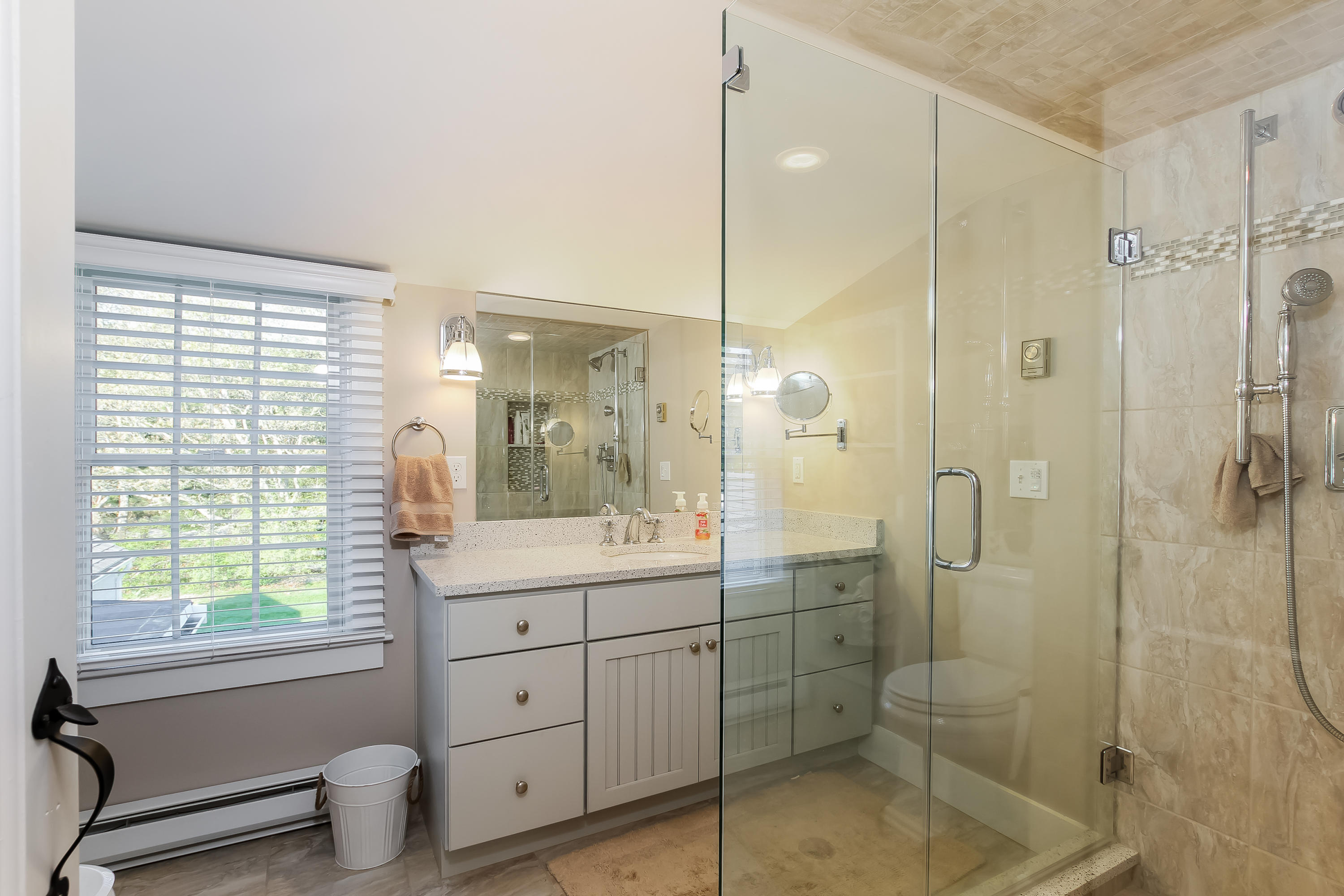 15 Colonial Way Harwich Port, MA 02646 - Photo 21 of 28 a bathroom with a shower sink vanity and mirror