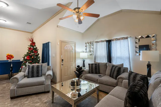 a living room with furniture and a potted plant