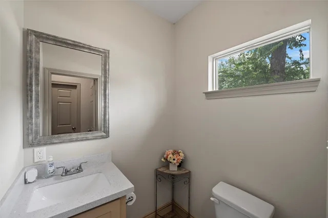 a bathroom with a sink a mirror and a window