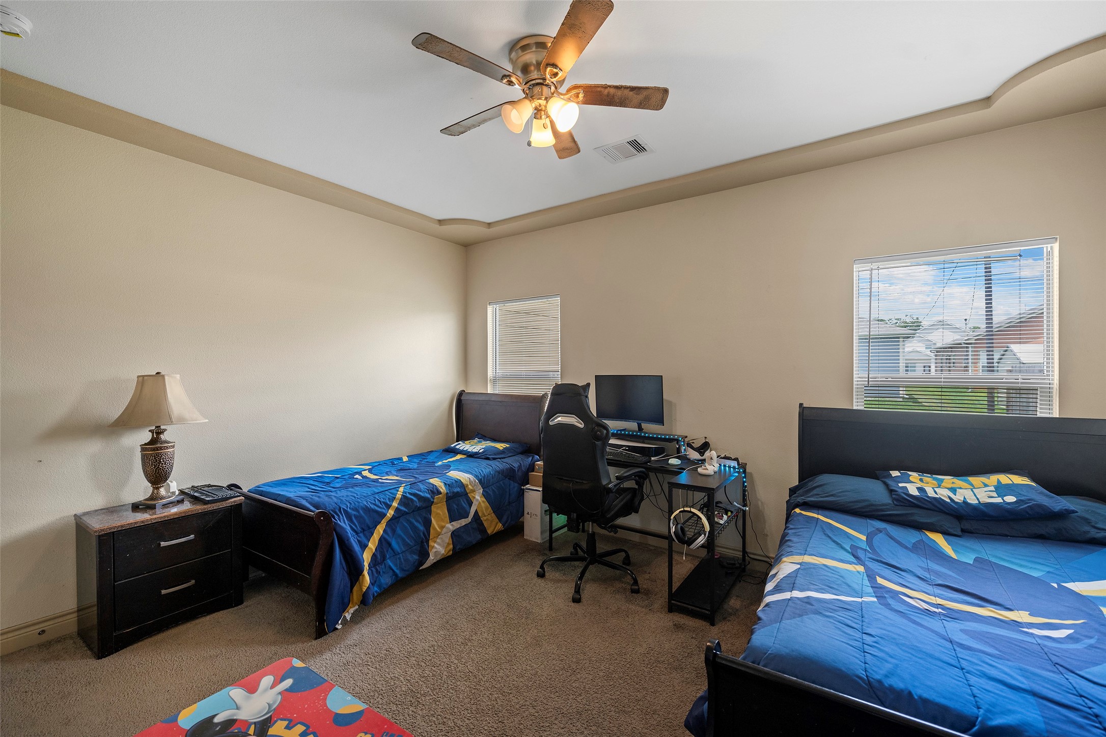 1541 3rd Street Hempstead, TX 77445 - Photo 14 of 26 a bedroom with a bed and a chandelier