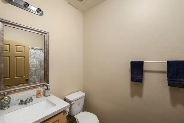 a bathroom with a sink a toilet and a mirror
