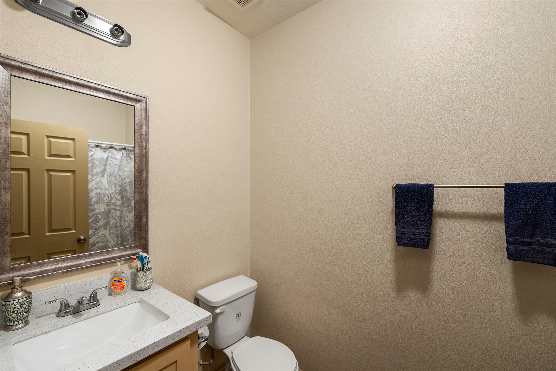 1541 3rd Street Hempstead, TX 77445 - Photo 15 of 26 a bathroom with a sink a toilet and a mirror