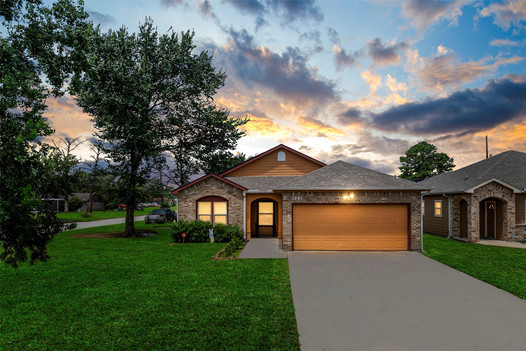 1541 3rd Street Hempstead, TX 77445 - Photo 19 of 26 a front view of a house with a garden and yard