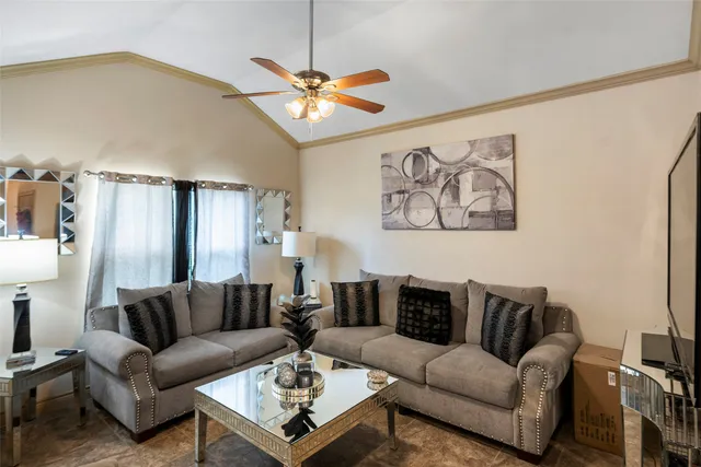 a living room with furniture a ceiling fan and a rug