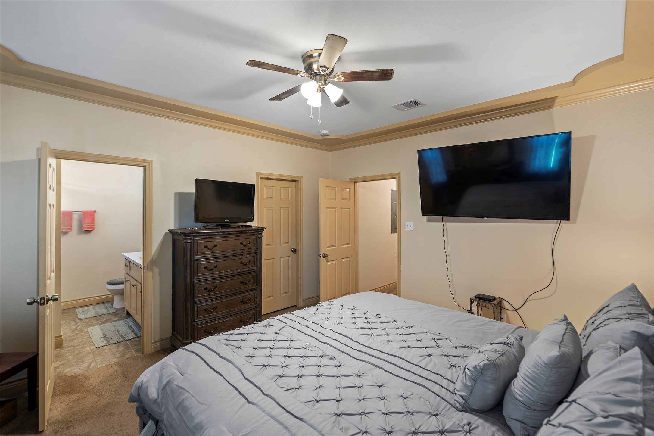 1541 3rd Street Hempstead, TX 77445 - Photo 8 of 26 a bedroom with a bed and a flat screen tv