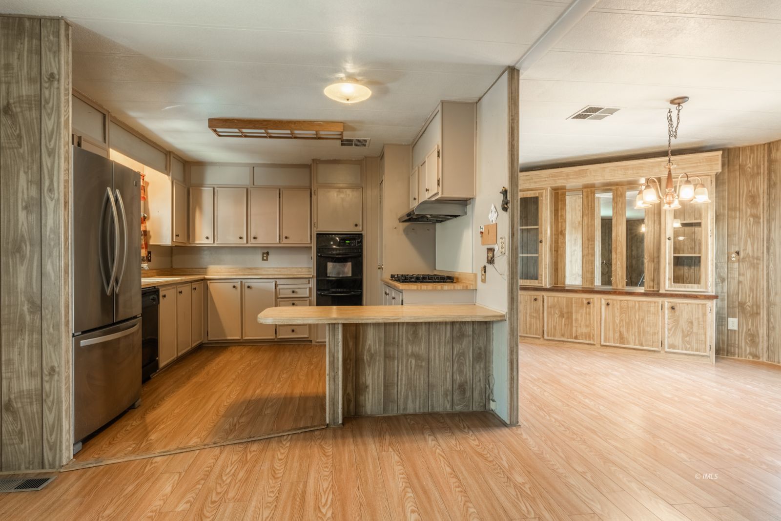1358 MacGregor Avenue Bishop, CA 93514 - Photo 6 of 30 a kitchen with stainless steel appliances a refrigerator a sink dishwasher a stove and white cabinets with wooden floor