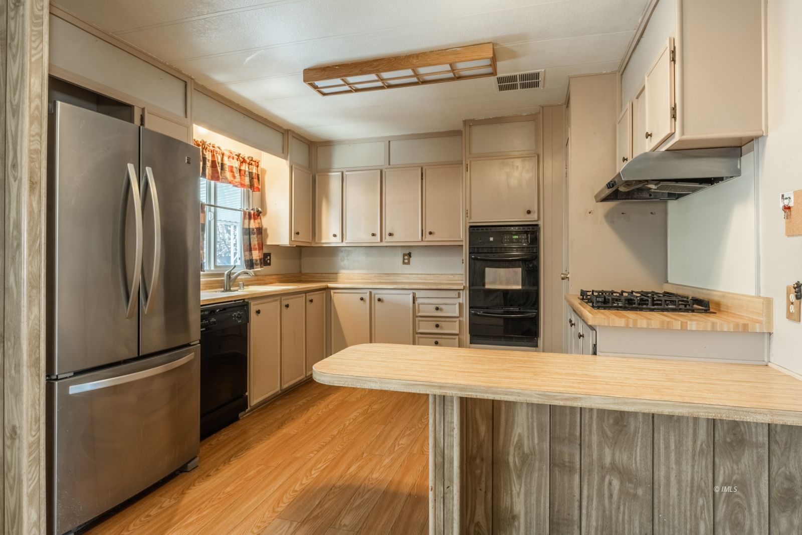 1358 MacGregor Avenue Bishop, CA 93514 - Photo 7 of 30 a kitchen with stainless steel appliances granite countertop a refrigerator a sink dishwasher a stove and white cabinets with wooden floor