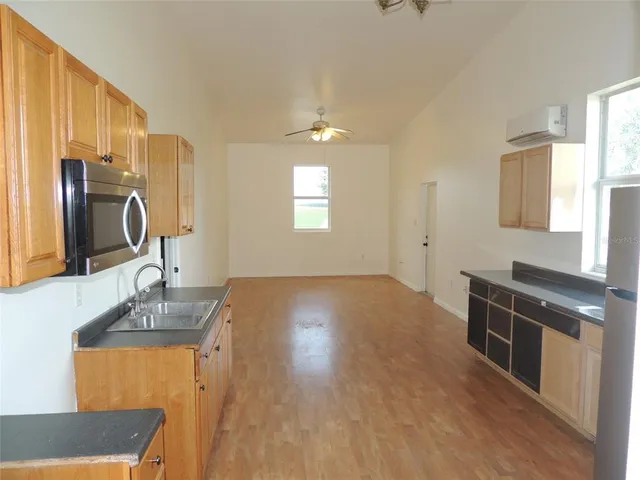 a view of a kitchen with a sink and a stove top oven