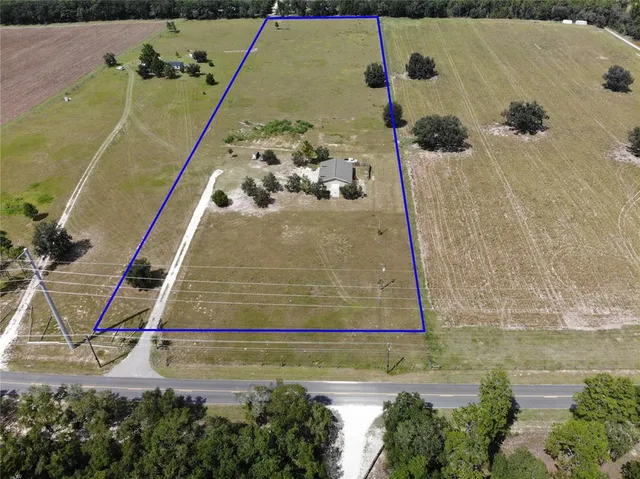 a front view of house with yard and trees