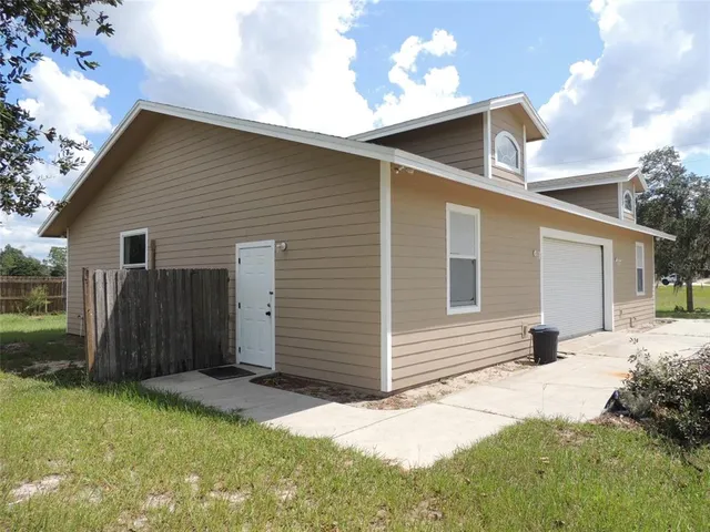 a view of a lake with a yard and mountain view