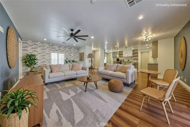 a kitchen with cabinets wooden floor and stainless steel appliances