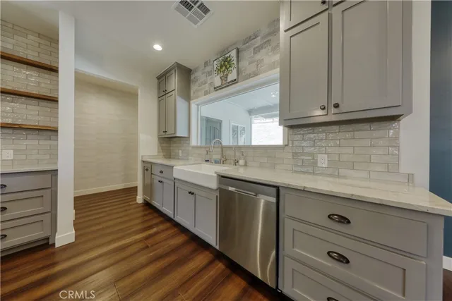 a view of a kitchen with wooden floor and window