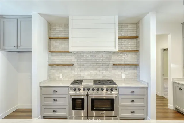 an empty room with a ceiling fan and window