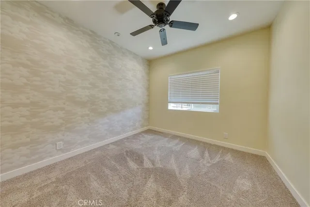 a bathroom with a granite countertop sink mirror vanity and toilet