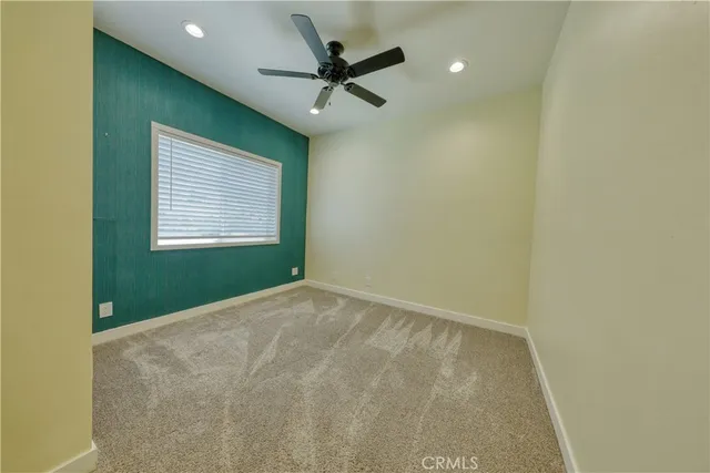a bathroom with a granite countertop sink a light fixture and a mirror