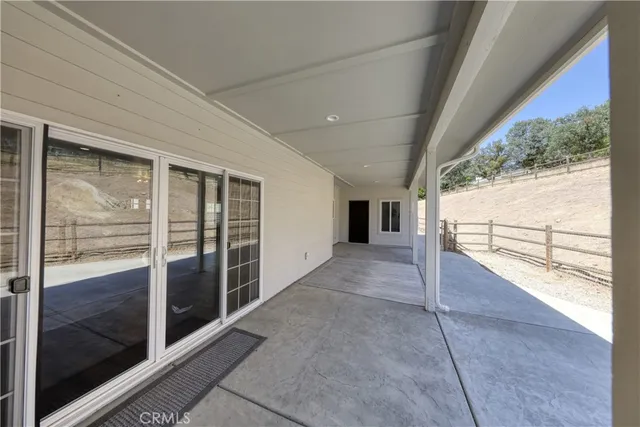 a view of empty room with a fireplace and window