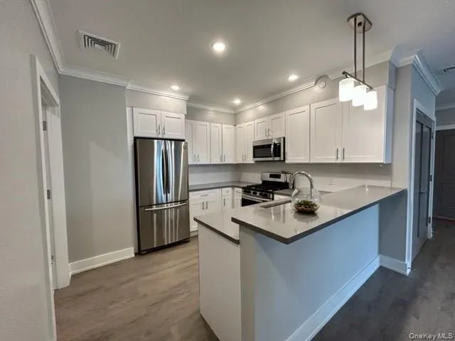 a kitchen with refrigerator a sink and a stove