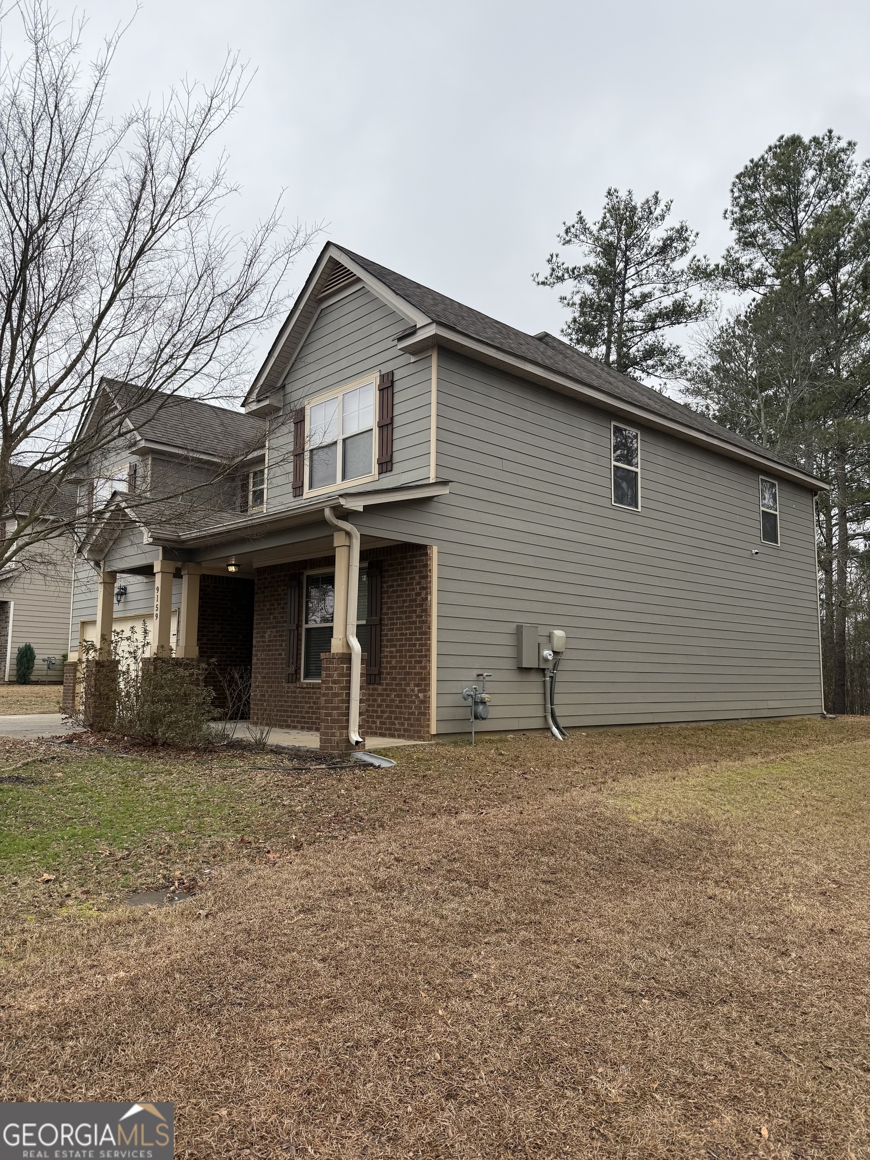9159 Dover Street Lithia Springs, GA 30122 - Photo 2 of 17 a house with trees in the background