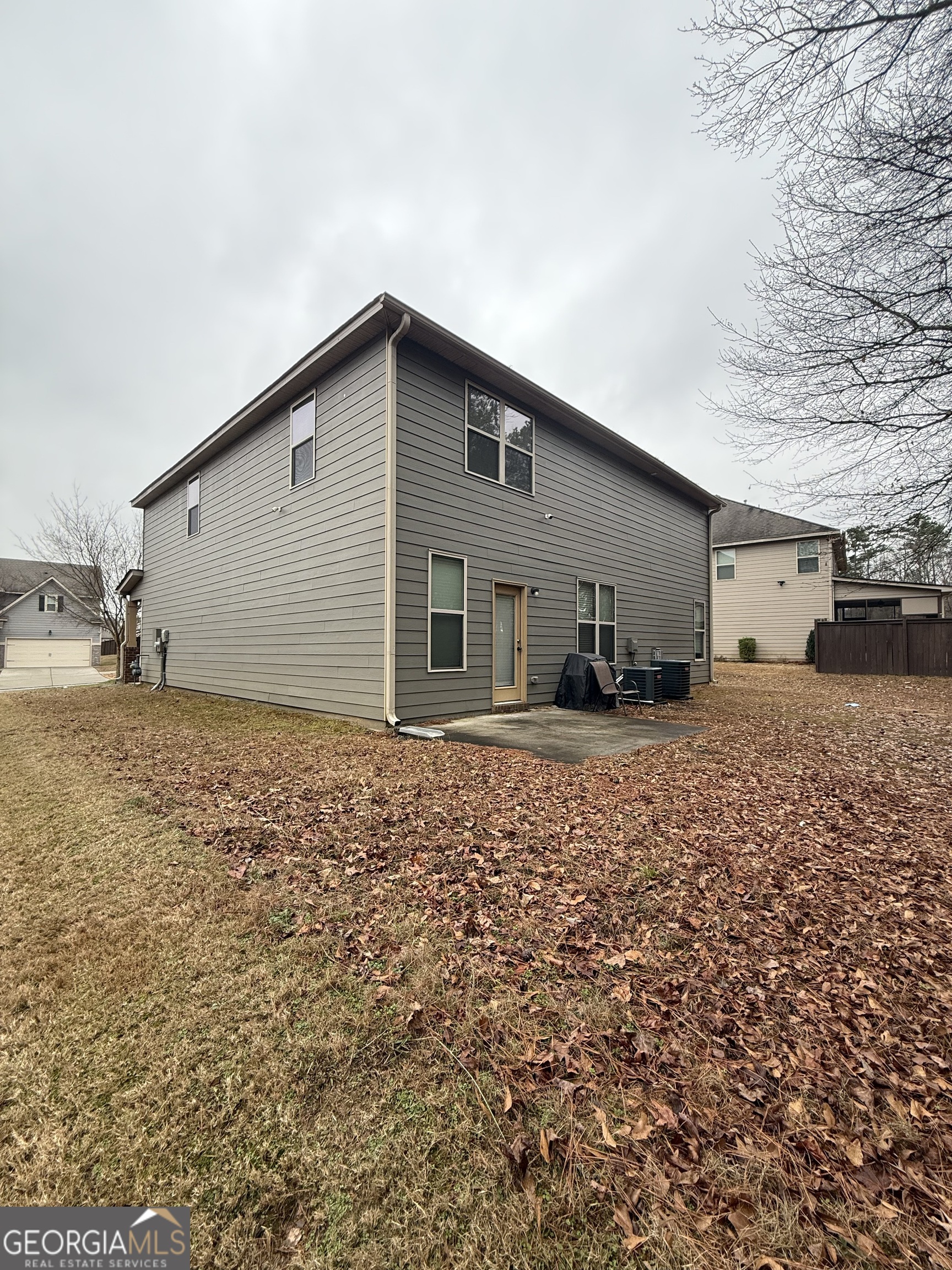 9159 Dover Street Lithia Springs, GA 30122 - Photo 3 of 17 a backyard of a house with table and chairs