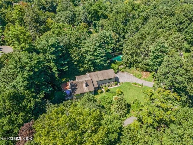 an aerial view of a house with a yard