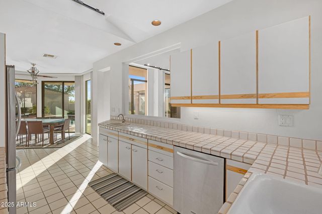 a spacious bathroom with a granite countertop sink and a mirror