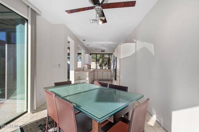 a room with pool table and windows