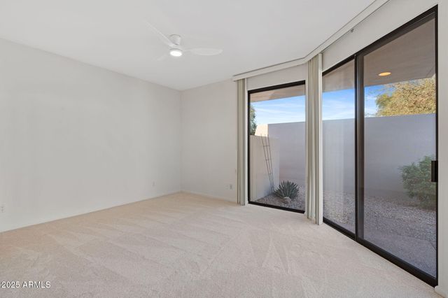 a view of a big room with windows and chandelier