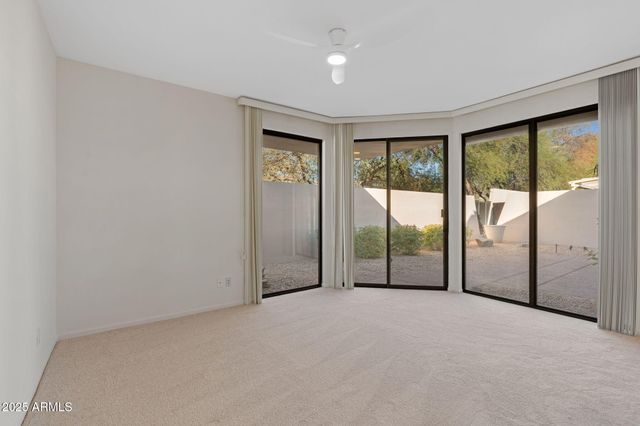 a bathroom with a granite countertop sink a toilet and a mirror