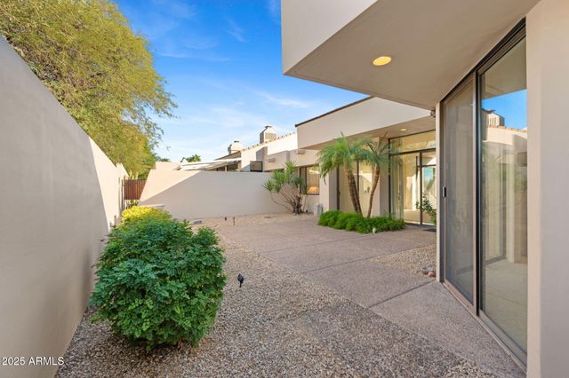a view of swimming pool with outdoor seating and plants